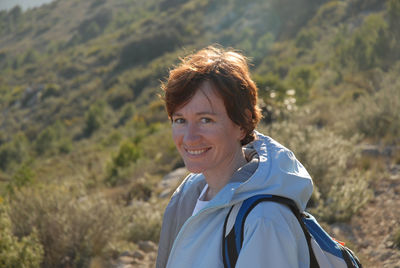 Portrait of smiling woman standing on field