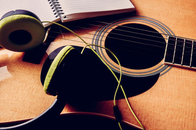 High angle view of headphones on guitar