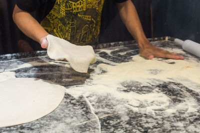 Midsection of man preparing food