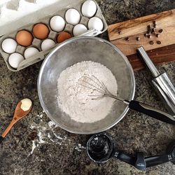 Directly above shot of flour and eggs on kitchen counter