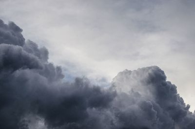 Low angle view of mountain against cloudy sky