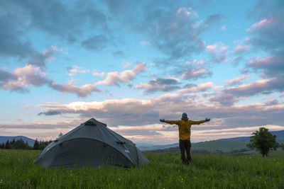 Man standing on field against sky