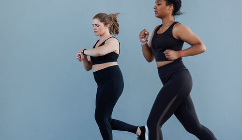 Side view of woman exercising in gym