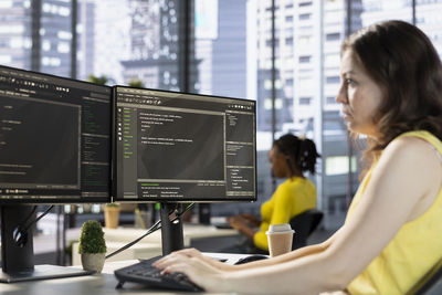 Midsection of woman using laptop