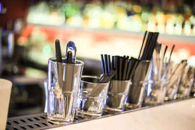 Close-up of stirrers at bar counter