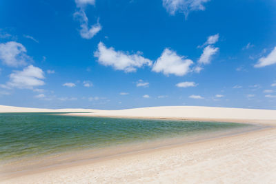 Scenic view of beach against blue sky