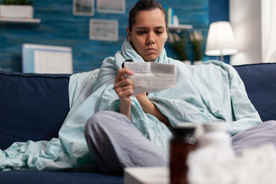 Young woman looking at prescription