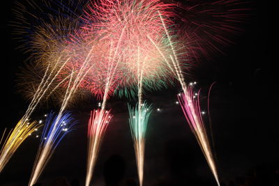 Low angle view of firework display at night