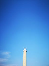 Low angle view of lighthouse against clear blue sky