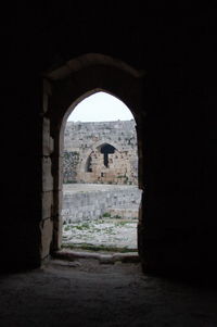 Old ruin building seen through arch window