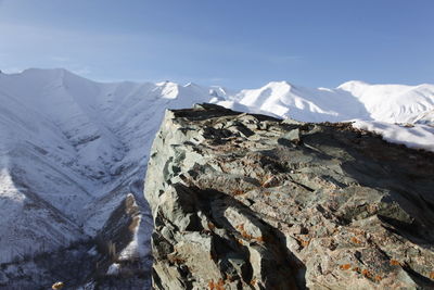 Scenic view of snow covered mountains against sky