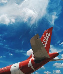 Low angle view of airplane flying against sky