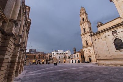 Buildings against cloudy sky