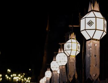 Low angle view of illuminated lanterns hanging at night