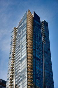 Low angle view of modern buildings against clear blue sky