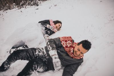 High angle view of woman standing on snow