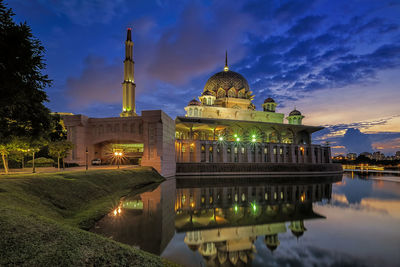 Reflection of temple in lake at sunset