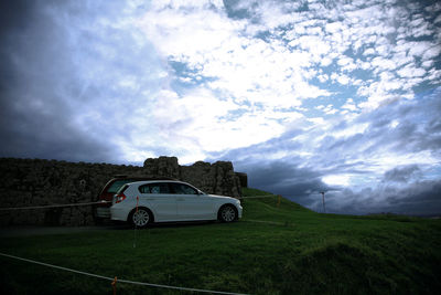 Car on landscape against sky