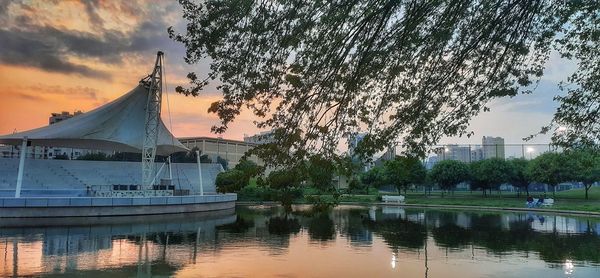 Reflection of building in lake during sunset