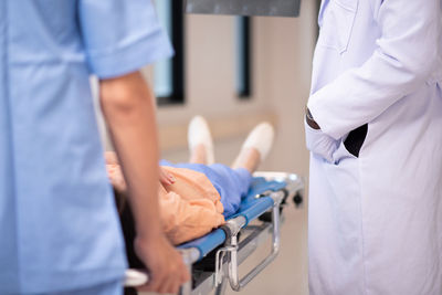 Midsection of doctor examining patient in hospital