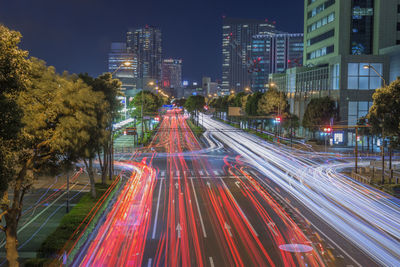 Light trails on road in city at night