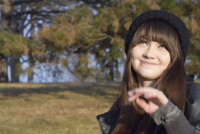 Close-up of happy teenager with lip piercing looking up