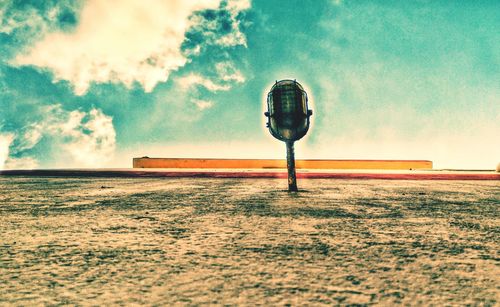 Street light on field against sky