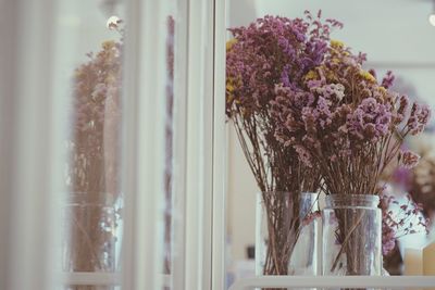 Close-up of flower vase against window