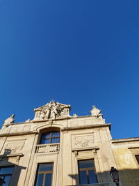 Low angle view of building against blue sky