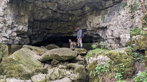 Rear view of man walking on rock formations