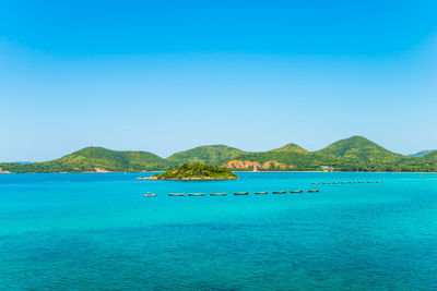 Scenic view of sea against clear blue sky