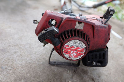 Red tank of lawn mower for mowing the lawn.lawn mower is type of mower sash