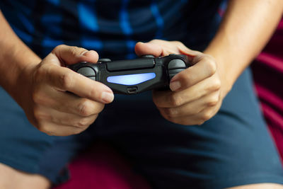 Close-up of a person playing the game console in the quarantine period