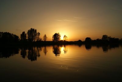 Scenic view of calm lake at sunset