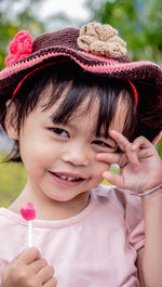 Portrait of cute girl holding hat