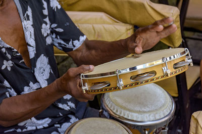 Musician playing tambourine in the streets of pelourinho in salvador during a samba performance