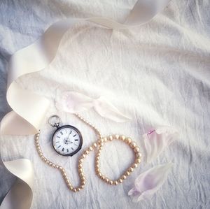 High angle view of clock on bed