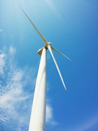 Low angle view of windmill against blue sky