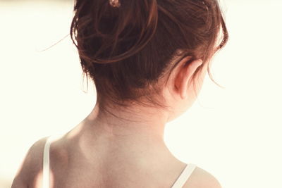 Close-up of woman against white background