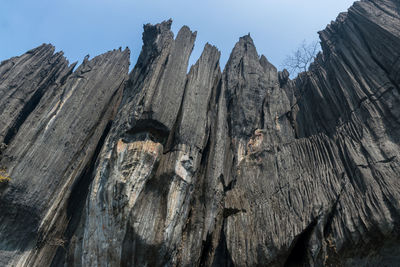 Low angle view of rock formation against sky