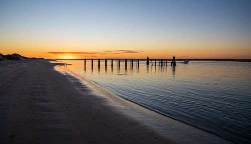 Scenic view of sea against clear sky during sunset