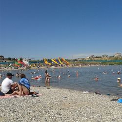 Two people sitting on beach