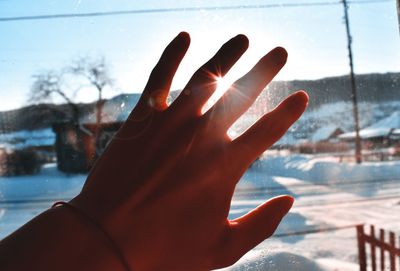Midsection of person against sky during winter