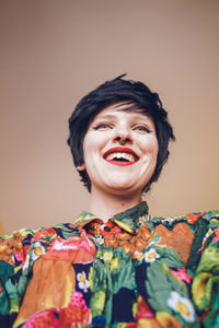 Smiling woman with make-up against colored background