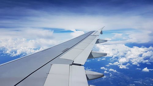 Cropped image of airplane flying in sky