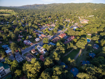 High angle view of houses amidst trees and buildings