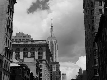 Low angle view of buildings against cloudy sky