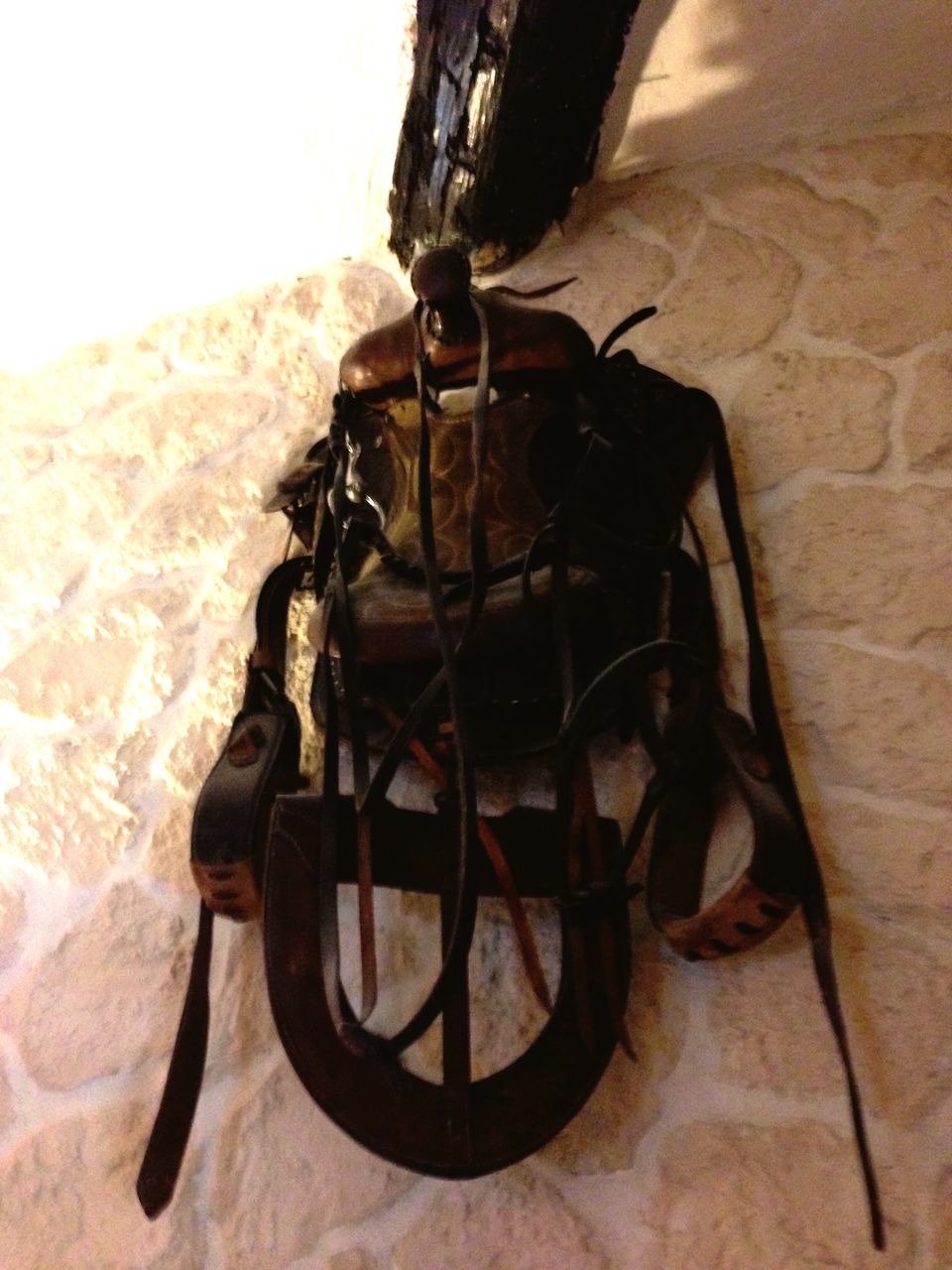 indoors, wall - building feature, shadow, close-up, still life, single object, no people, sunlight, table, absence, home interior, high angle view, wall, old-fashioned, metal, day, hanging, wood - material, shoe, chain