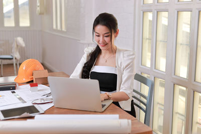 Young woman using laptop on table