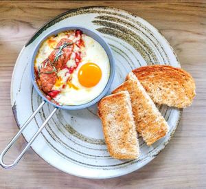 High angle view of chorizo and egg served by toasted bread in plate on table